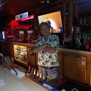 a man standing behind a bar