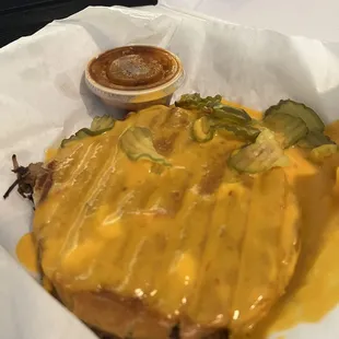 Brisket Sammich covered in queso and pickles