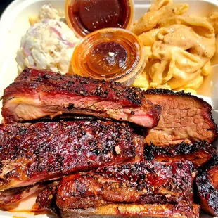 A mix of delicious BBQ with potato salad and mac and cheese.