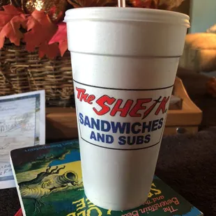 a paper cup with a straw