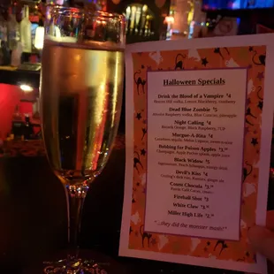 a menu and a glass of wine