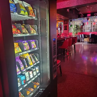 Vending machine stocked with chips, crackers, pretzels, m&amp;ms, smokes and lighters