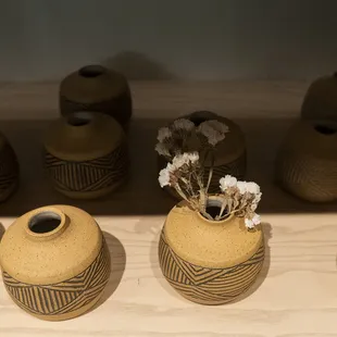 a row of vases with flowers in them