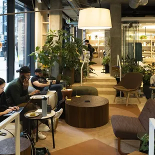 people sitting at tables in a coffee shop