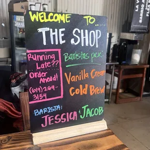 Welcome sign at the barista counter with their favorite drinks, contact info and name of the baristas