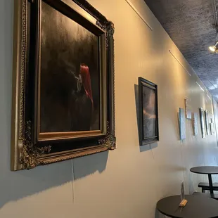 a hallway with paintings on the wall