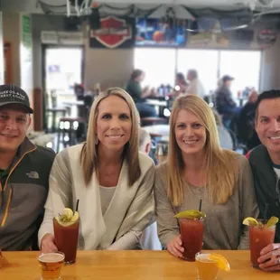 a group of people sitting at a bar