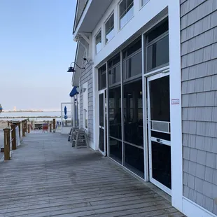 a boardwalk with tables and umbrellas