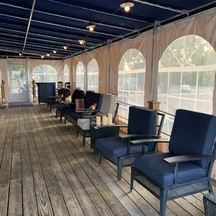 a row of chairs on a wooden deck