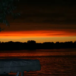 a boat on the water at sunset