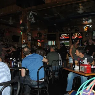 people sitting at tables in a bar