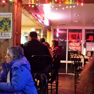 people sitting at tables in a restaurant