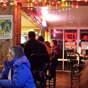 people sitting at tables in a restaurant