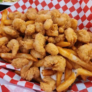 a basket of fried shrimp and fries