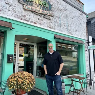 a man standing outside of a restaurant