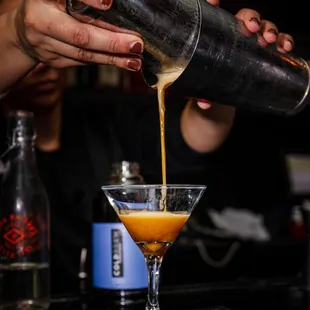 a bartender pouring a drink