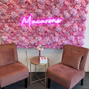 two chairs in front of a floral wall