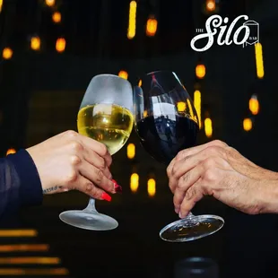 two people toasting wine glasses