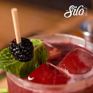 a blackberry drink with ice and mint