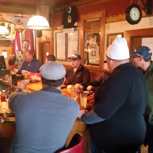 a group of men sitting at a bar