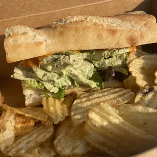 Green goddess chicken sandwich with chips.
