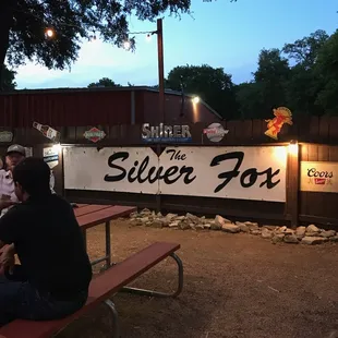 a group of people sitting at a picnic table