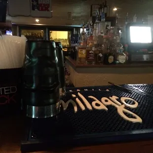 a bar with a black and white sign