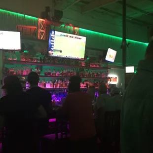 a group of people sitting at a bar