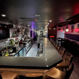 a long bar with chairs