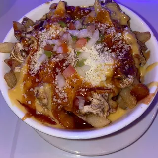 Jerk Chicken cheese fries with pico de gallo