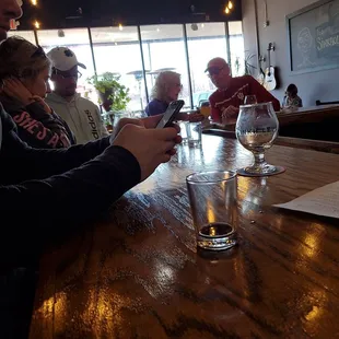 a group of people sitting at a bar
