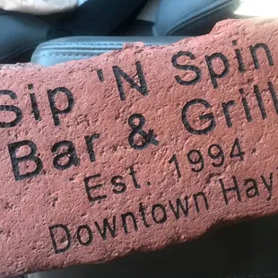  brick with the name of a bar and grill