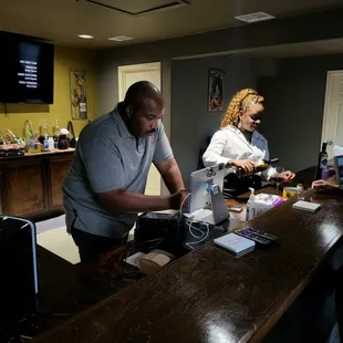 a man and a woman at a bar