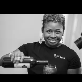 a woman pouring a drink