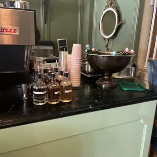 a coffee machine and cups on a counter