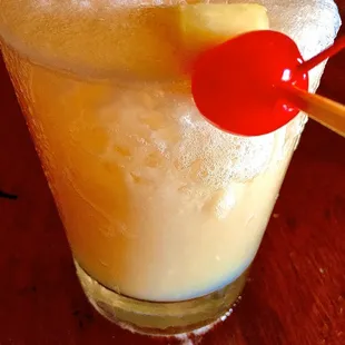 a cocktail with pineapple garnish