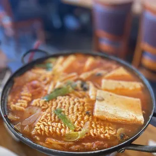 a bowl of soup with noodles and tofu