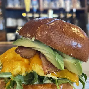Breakfast egg sandwich!!!! Bacon , avocado , arugula, pesto aoli, brioche bun