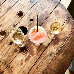 three glasses of wine on a wooden table