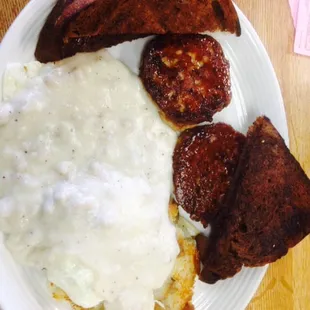 Potato pancakes with sausage gravy and 2 over easy eggs plus sausage patties......very greasy breakfast