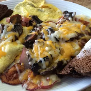 Awesome ham and cheese omelette with mushrooms covered with cheese and rye toast excellent food at the skillet!!