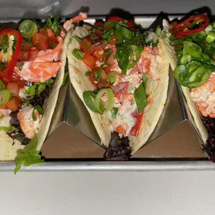 three tacos on a tray