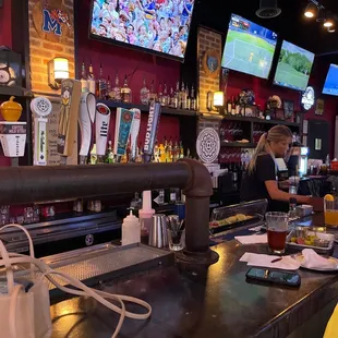 a bar with people sitting at the bar