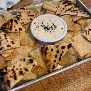 a tray of pita chips and dip