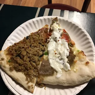 a slice of pizza on a paper plate