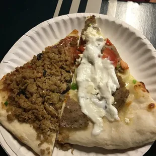 two slices of pizza on a paper plate