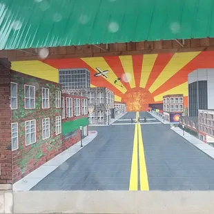 a mural of a city street