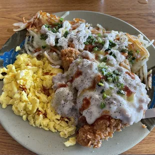 Chicken fried steak with scrambled eggs, loaded potatoes and all the hot sauce.