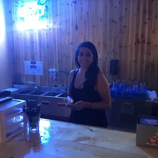 a woman standing at a counter in a restaurant