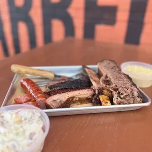 a tray of meat and sides